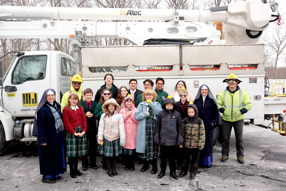 You never know what to expect at St. Joseph’s! Students and Sisters pose with electrical crew (Wayne, Michigan).