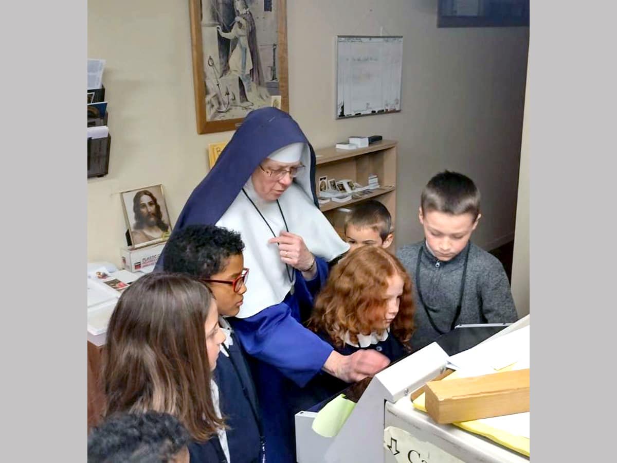 Students from Mary Immaculate Queen School in Idaho visit Mount St. Michael for a tour of the host room and print shop.