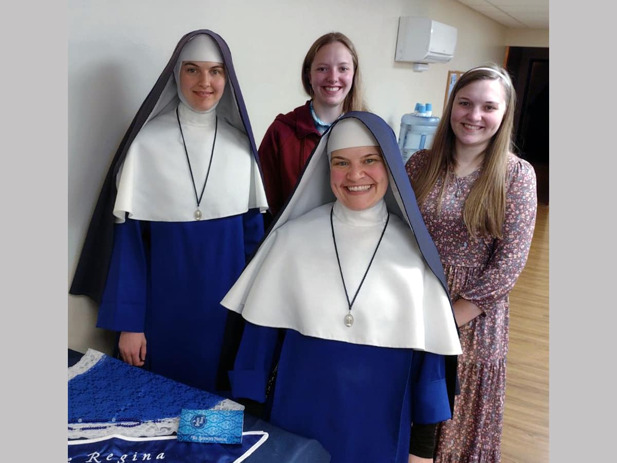Sr. Michael Marie poses with three of the original Sodalists.