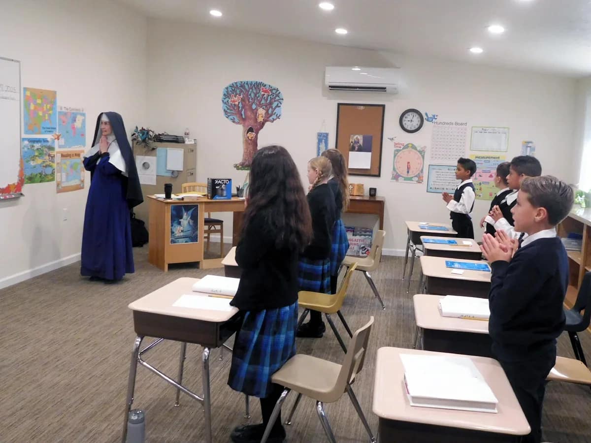 Prayers before classes are a normal part of every CMRI school — more fervent, of course, on test days. (Sr. Madeleine Marie and her class at Mary Immaculate Queen Academy, Rathdrum, Idaho.)