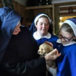 On Ascension Thursday, we had the opportunity to play with ten 10-week old retriever puppies. Sister Maria looks on as Sister Alena shows a puppy to Sister Mary Paula.