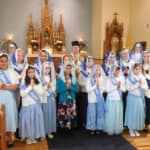 Sr. Mary Imelda and Sr. Mary Genevieve pose with members of Salve Regina Sodality and Children of Mary after advancement ceremonies on December 8 at the City of Mary, Rathdrum, Idaho. Advancement ceremonies for the Salve Regina Sodality and Children of Mary took place on December 8 at the City of Mary, Rathdrum, Idaho.