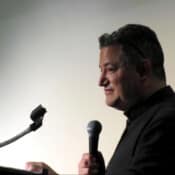 Fr. Michael Anaya keeps the schedule moving smoothly.