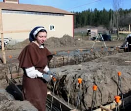 Sisters help to prepare for the new foundation to be laid.