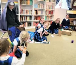 Sister Mary Lucy watches as students open Epipahny gifts at Holy Guardian Angels school in Olathe, Colorado.