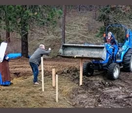 Mr. Stevens directs Sr. Virginia as she manuevers the tractor.