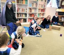 Sister Mary Lucy watches as students open Epipahny gifts at Holy Guardian Angels school in Olathe, Colorado.