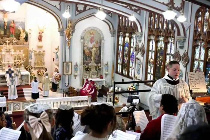 Fr. Philip Davis, CMRI, directs the high school choir during the Pontifical High Mass at the Fatima Conference.