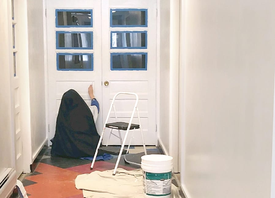 Painting the entrance to the parish hall.