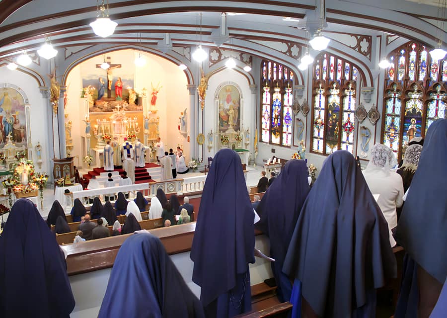 Sisters and students sing during the pontifical high Mass during the Fatima Conference at Mount St. Michael.