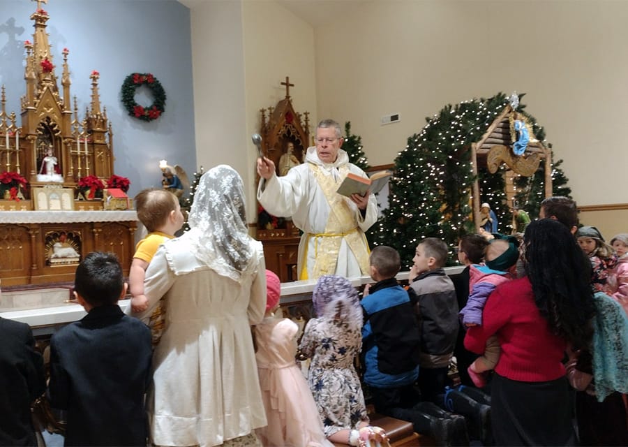 Fr. Benedict Hughes, CMRI, gives a special blessing to children of Mary Immaculate Queen Parish (Rathdrum, Idaho).