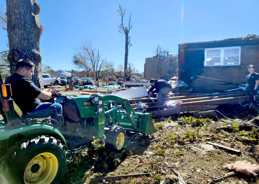 Seminarians help clean up the property of a parishioner in Oklahoma whose home was destroyed by a tornado in November.