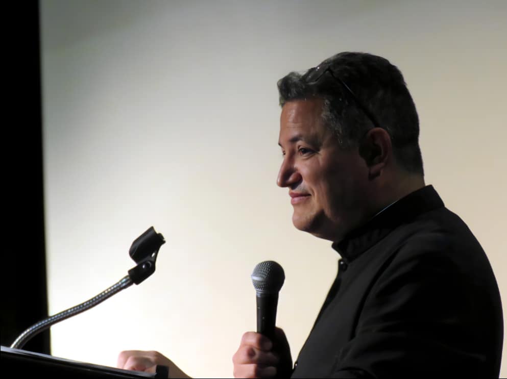 Fr. Michael Anaya keeps the schedule moving smoothly.