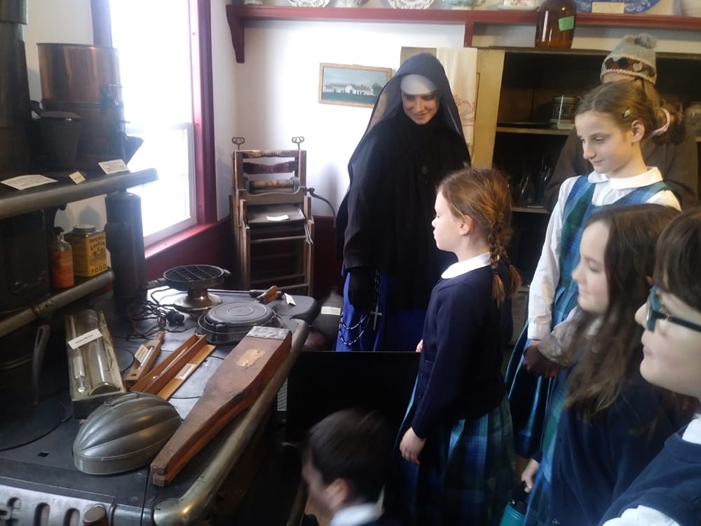 Sr. Mary Teresita and students of St. Theresa School (Oakland, Maine) look at artifacts displayed in the Redington Museum in Waterville, Maine, a two-story house dating back to 1814.