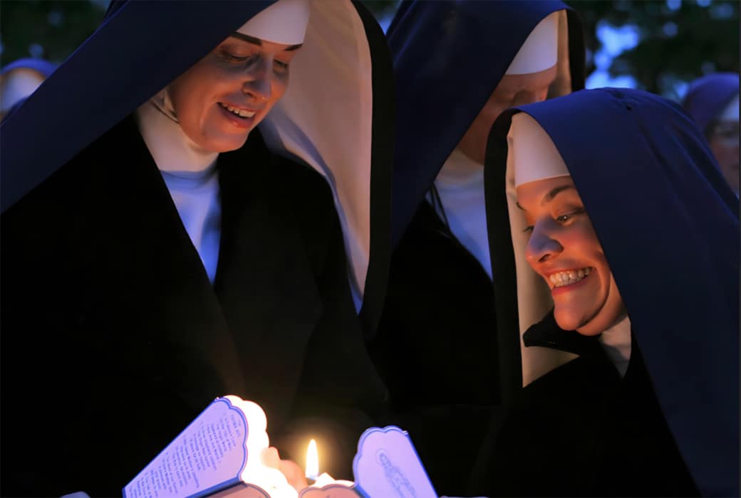 Spread the light! Two Sisters prepare for the candlelight procession in honor of Our Lady during the Fatima Conference.