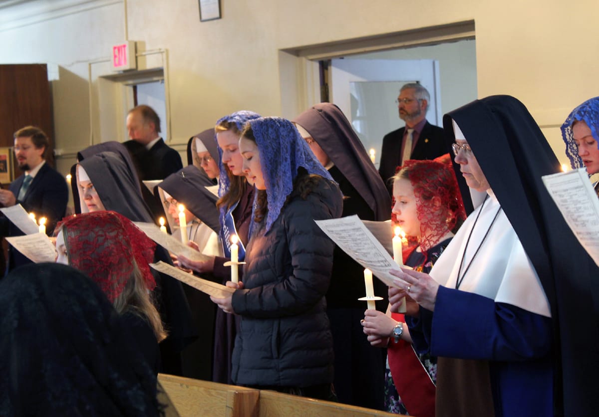 Sisters and Sodalists congregate in the back of St. Michael’s Chapel in preparation for the Candlemas procession that ends the Christmas season.