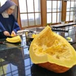 How many pumpkin pies can you make out of a 75-pound pumpkin? Sister Mary Antoinette chops up a monster of a pumpkin from the novitiate garden.