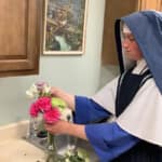 Sr. Philomena Marie arranges flowers for an upcoming feast. Sisters on mission often help with sacristy work and preparing the altar for Holy Mass.