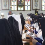 After formally processing into the church with lighted candles, the Sisters conclude the chanting of the solemn Salve Regina from their places.