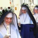 First Vows: Sr. Mary Lucy, Sr. Maria Goretti and Sr. Mariana wear crowns of red and white roses, symbolic of the life of purity and martyrdom they have chosen.