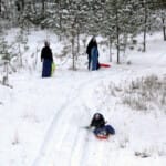 During the Christmas break, the Novitiate Sisters enjoy the freshly fallen snow sledding down the hill.