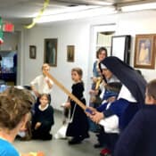 Andale, Nino!! Sr. Maria Dolorosa gets a young pinata enthusiast pointed in the right direction during the All Saints’ Day party (Middleville, Michigan).