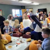 Pumpkin carving at the All Saints’ Day party at Holy Guardian Angel’s school in Olathe, Colorado. Sr. Mary Lucy steps in to prevent a mishap.
