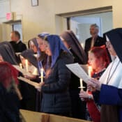 Sisters and Sodalists congregate in the back of St. Michael’s Chapel in preparation for the Candlemas procession that ends the Christmas season.