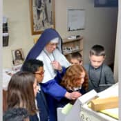 Students from Mary Immaculate Queen School in Idaho visit Mount St. Michael for a tour of the host room and print shop.