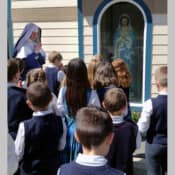 Sr. Mary Genevieve leads the Regina Coeli by the bell tower shrine to Our Lady (Mary Immaculate Queen Church, Rathdrum, Idaho).