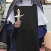 Temporary profession of vows for three years precedes the taking of final vows. The large brown scapular is received at this step by Sr. Mary Fatima.