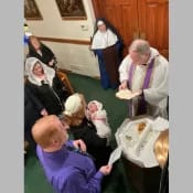 Sr. Bernardine Marie looks on while Father Francisco Radecki baptizes a tiny new parishioner of St. Joseph’s Church inWayne, Michigan. Sr. Bernardine Marie looks on while Father Francisco Radecki baptizes a tiny new parishioner of St. Joseph’s Church inWayne, Michigan.