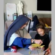 Sr. Sophia Marie helps a young student with a catechism project during a weekend mission in Boise, Idaho. Sr. Sophia Marie helps a young student with a catechism project during a weekend mission in Boise, Idaho.
