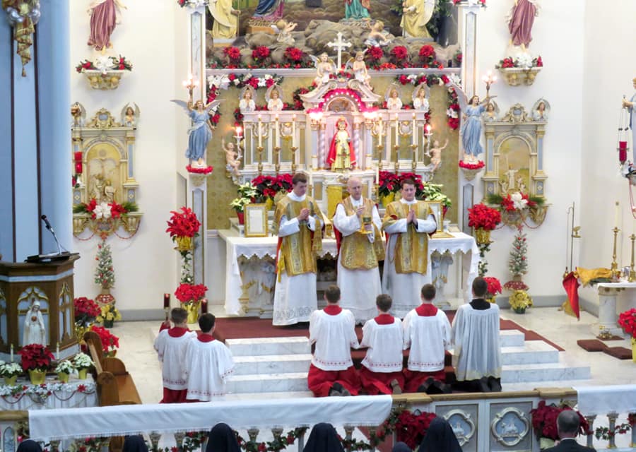 Christmas Midnight Mass at Mount St. Michael: Fr. Casimir Puskorius, CMRI, is assisted by Rev. Frater Martin Marie Sentmen, CMRI, and seminarian Richard Lauricella as straw subdeacon.