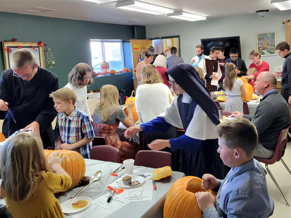 Pumpkin carving at the All Saints’ Day party at Holy Guardian Angel’s school in Olathe, Colorado. Sr. Mary Lucy steps in to prevent a mishap.