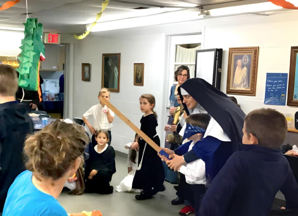 Andale, Nino!! Sr. Maria Dolorosa gets a young pinata enthusiast pointed in the right direction during the All Saints’ Day party (Middleville, Michigan).