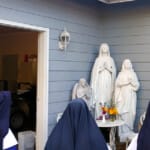 On the 100th anniversary of the blessing of Lourdes Grotto at Mount St. Michael, the Sisters at MIQ Parish made a “pilgrimage” to the original statue to pray the Rosary. After the statue was vandalized in 2009, and the missing pieces found, a parishioner at MIQ Parish restored it, and now lovingly keeps it to await a new grotto of its own.