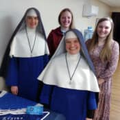Sr. Michael Marie poses with three of the original Sodalists.