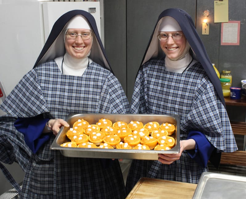Sisters show their yam-stuffed oranges